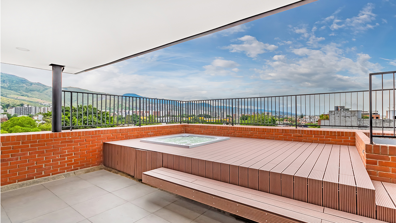 Foto real de la terraza Biflora, donde se aprecia un hermoso mueble para pasar el tiempo, freso y amplio, donde encuentran el jacuzzi y zona bbq.